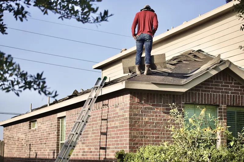Professional roofer working on a residential roof in Roselawn